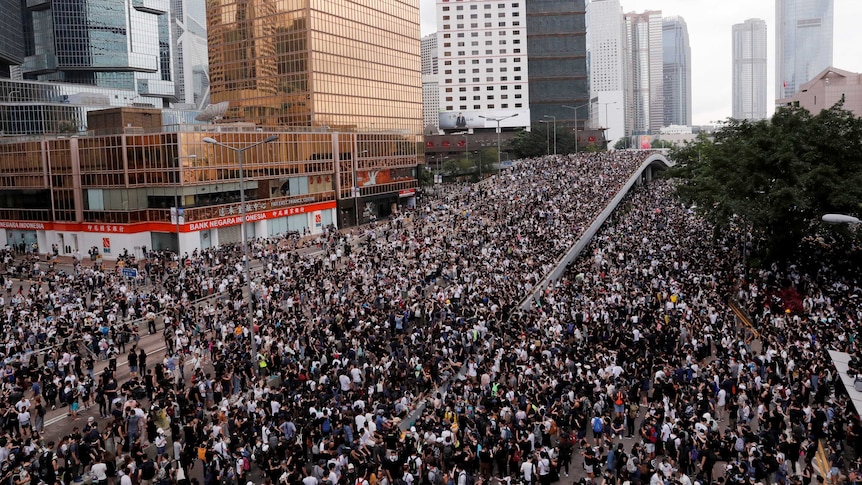 Protesters march along a road during a demonstration against a proposed extradition bill in Hong Kong.