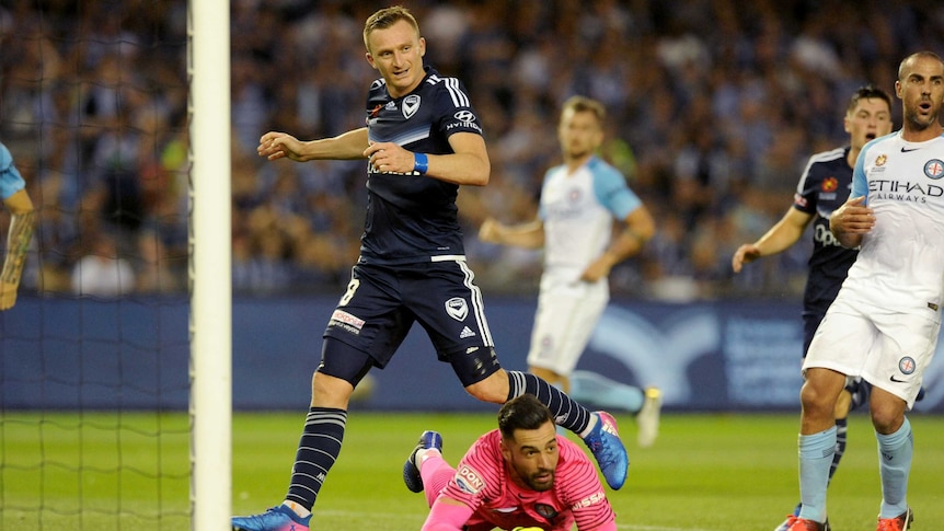 Dean Bouzanis saves a goal as Besart Berisha looks on during Saturday night's Melbourne Derby.