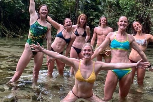 A group of Olympic swimmers at a waterhole.