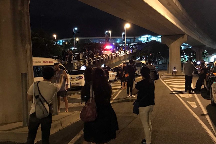 Crowds gather and traffic is backed up outside brisbane airport