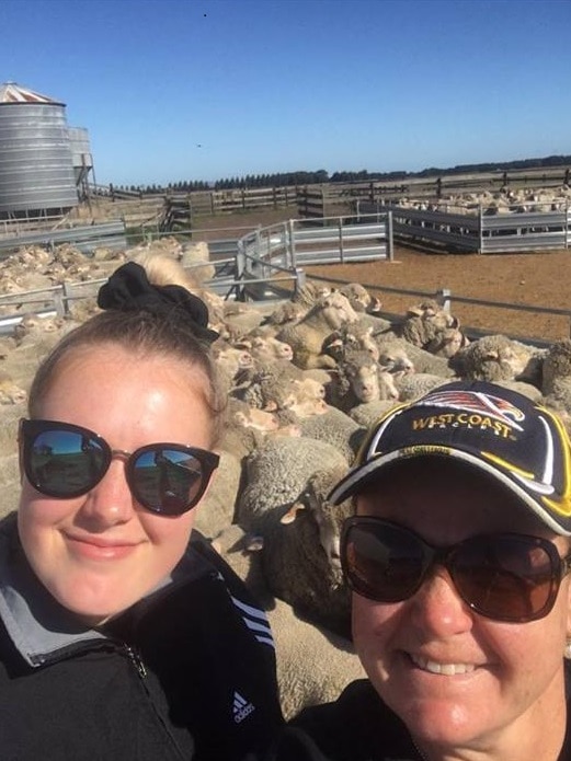 Kate Johnston with her mum Sue Johnston on their farm surrounded by sheep