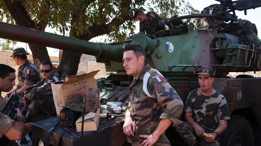 French soldiers stand next to a tank at a Malian air base in Bamako.