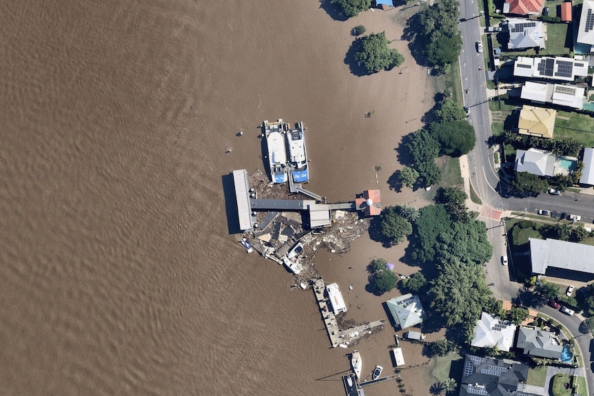 An aerial view of flood debris at a ferry terminal on the Brisbane River.