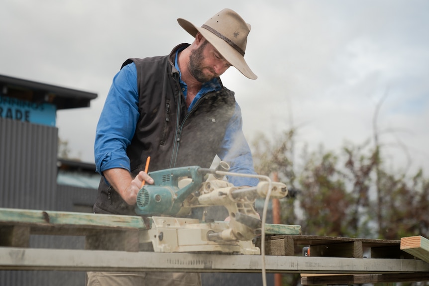 Lachlan Ward cutting wood.