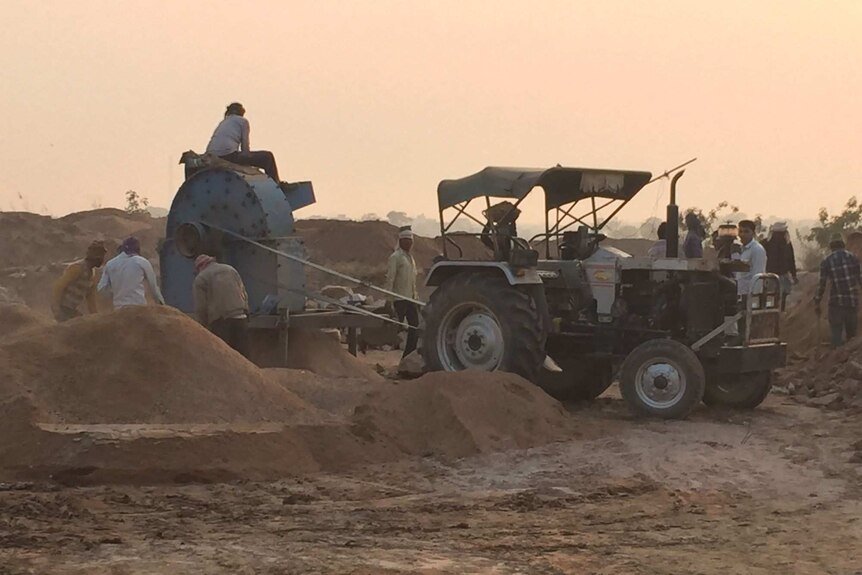 A sand mining tractor operating in broad daylight near Noida.