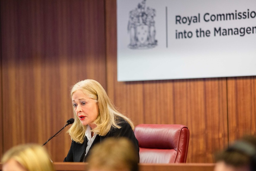 A woman sitting at a legal bench.