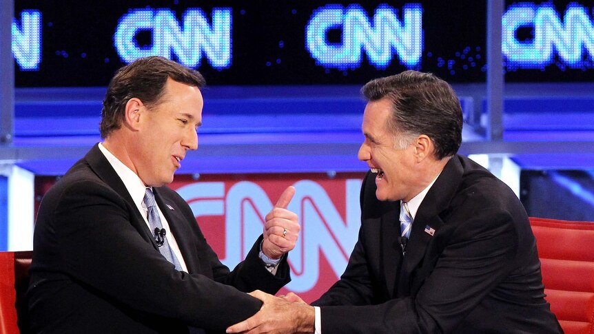 Rick Santorum (left) and Mitt Romney share a laugh after an at-times heated debate in Arizona.