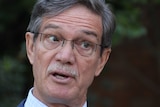 Close up photo of Mike Nahan wearing glasses and speaking.