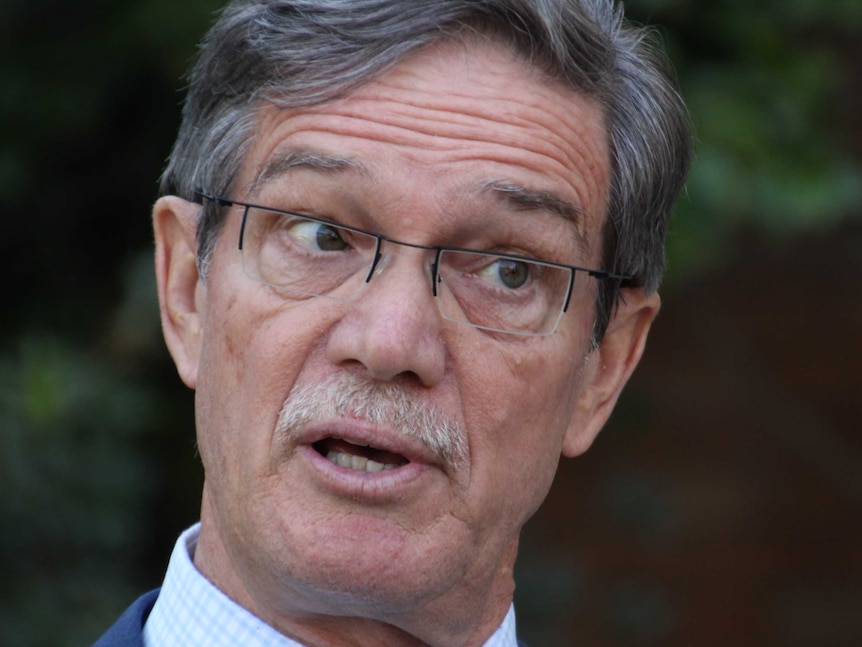 Close up photo of Mike Nahan wearing glasses and speaking.