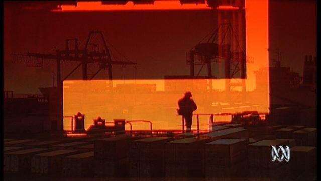 Sillhouette of man standing on shipping dock