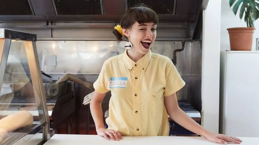 Stella Donnelly winking at the camera in the music video for 'Mechanical Bull'