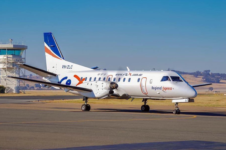 A rex plane sits on the tarmac.