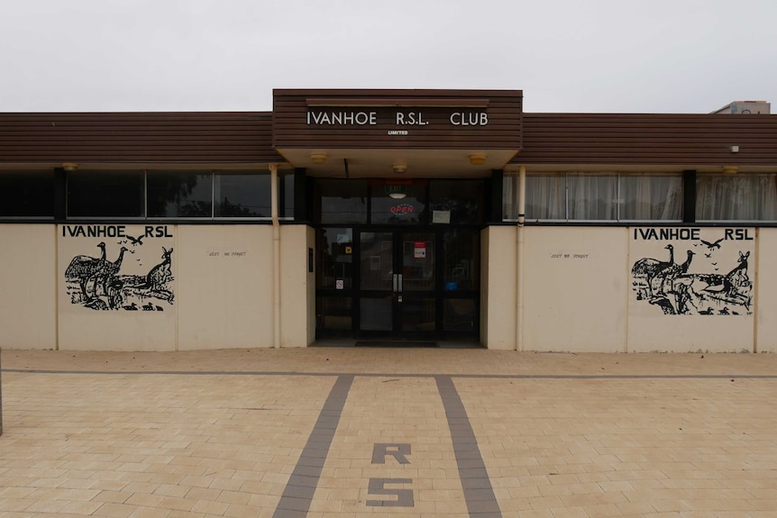 The facade of the Ivanhoe RSL club, with a mural featuring Australian animals on either side of double doors.