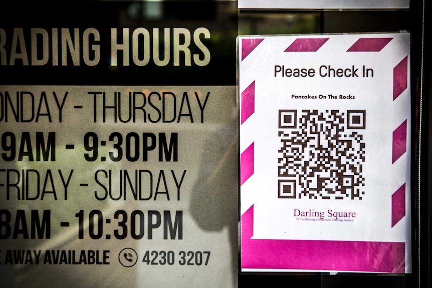 signage of restaurant opening times next to a pink QR code