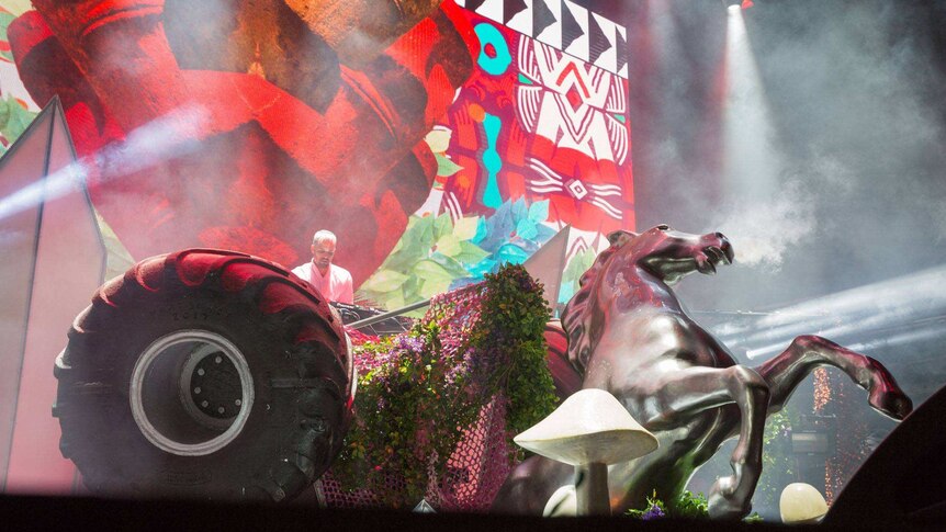 What So Not performs in front of a multicoloured projection on a deck shaped like a giant horse pulling a monstertruck