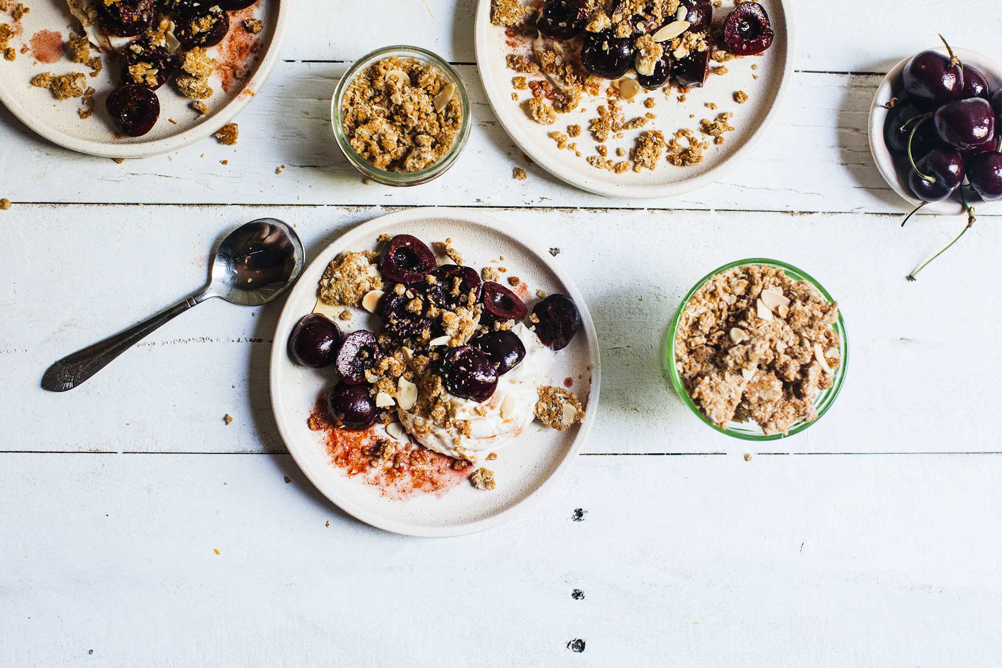 Individual dessert plates with whipped mascarpone, cherries and Anzac crumble for a festive and easy dessert recipe.