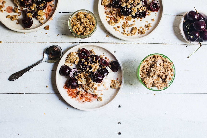 Individual dessert plates with whipped mascarpone, orange soaked cherries and Anzac crumble for a festive and easy dessert.