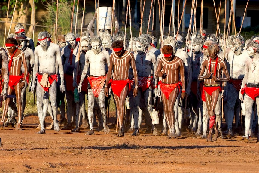 Men march forward at a traditional ceremony in Wadeye.