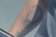 A blurry image of a tattoo on a man's forearm.