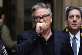 Alec Baldwin leaves a Manhattan court, covering his mouth with his hand, January 2019.