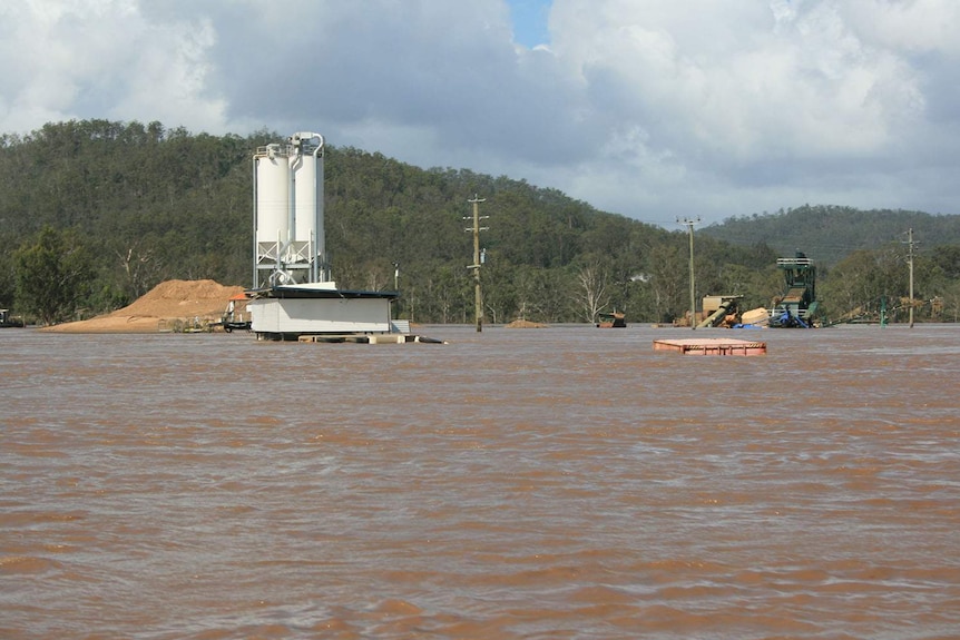 Flooded Zanow family’s quarry business and heavy vehicle equipment in Fernvale, west of Brisbane.