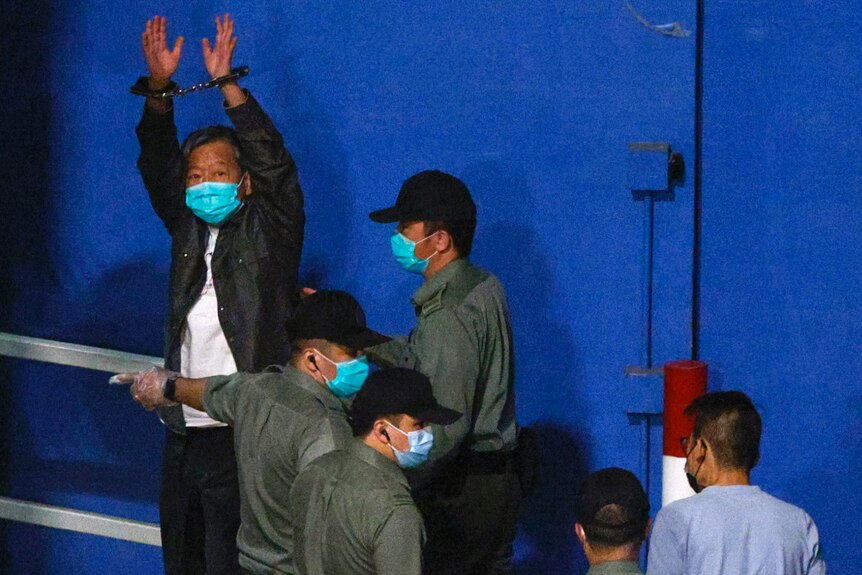 Lee Cheuk-yan raises his hands as he arrives at Lai Chi Kok Reception Centre by prison