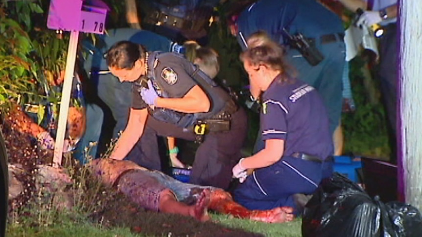 A stabbing victim is treated by paramedics