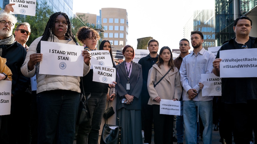 People standing together holding signs 