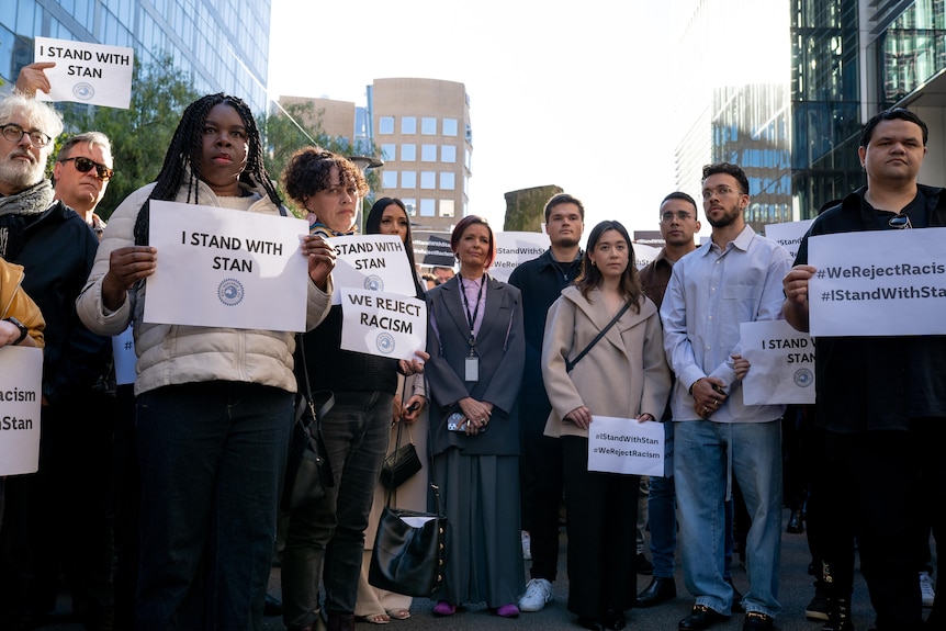 People standing together holding signs 