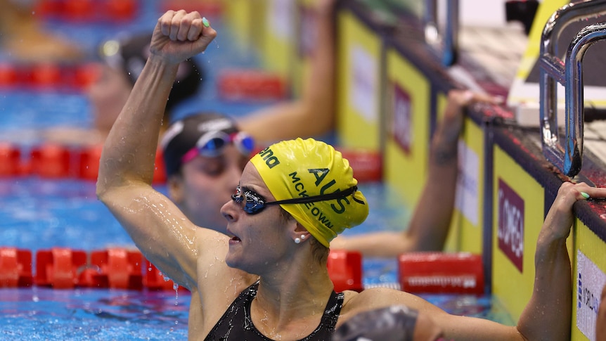 An Australian swimmer punches the air with her right hand after winning a world championship final race..