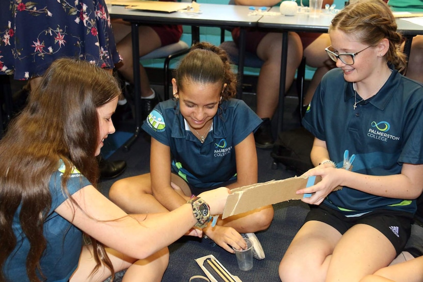 Three students work on a project at the Power of Engineering workshop in Darwin.