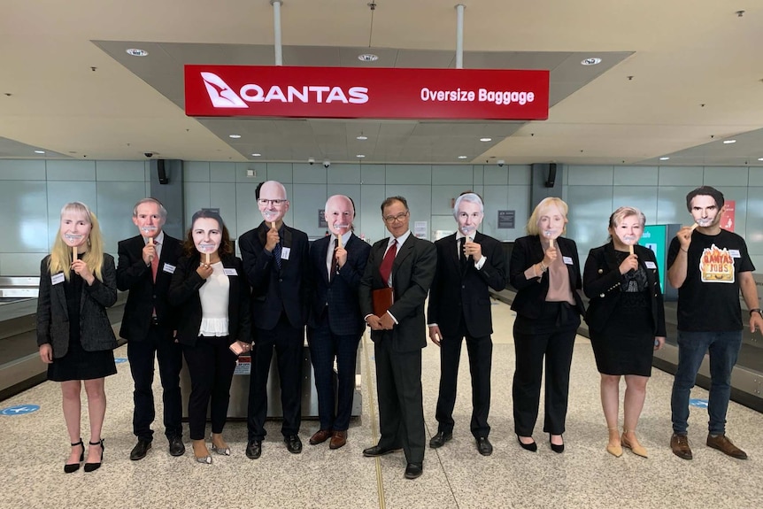 a bunch of people with masks on at an airport