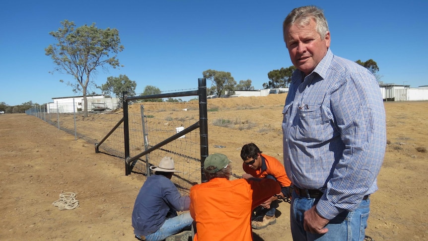 RAPAD Employment Services' Tony Rayner with job seekers constructing a wild dog fence around the Longreach Pastoral College.