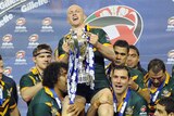 Darren Lockyer lifted up by team-mates holding up Four Nations trophy