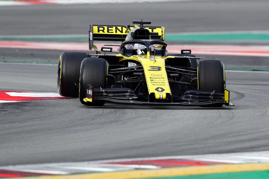 A Formula One car goes through a corner in pre-season testing.