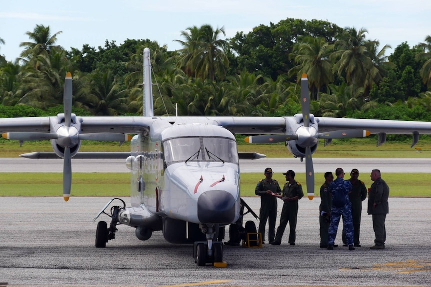 The crew of an Indian Air Force Dornier 228 aircraft meet with member of the ADF at the Cocos Island's airfield 