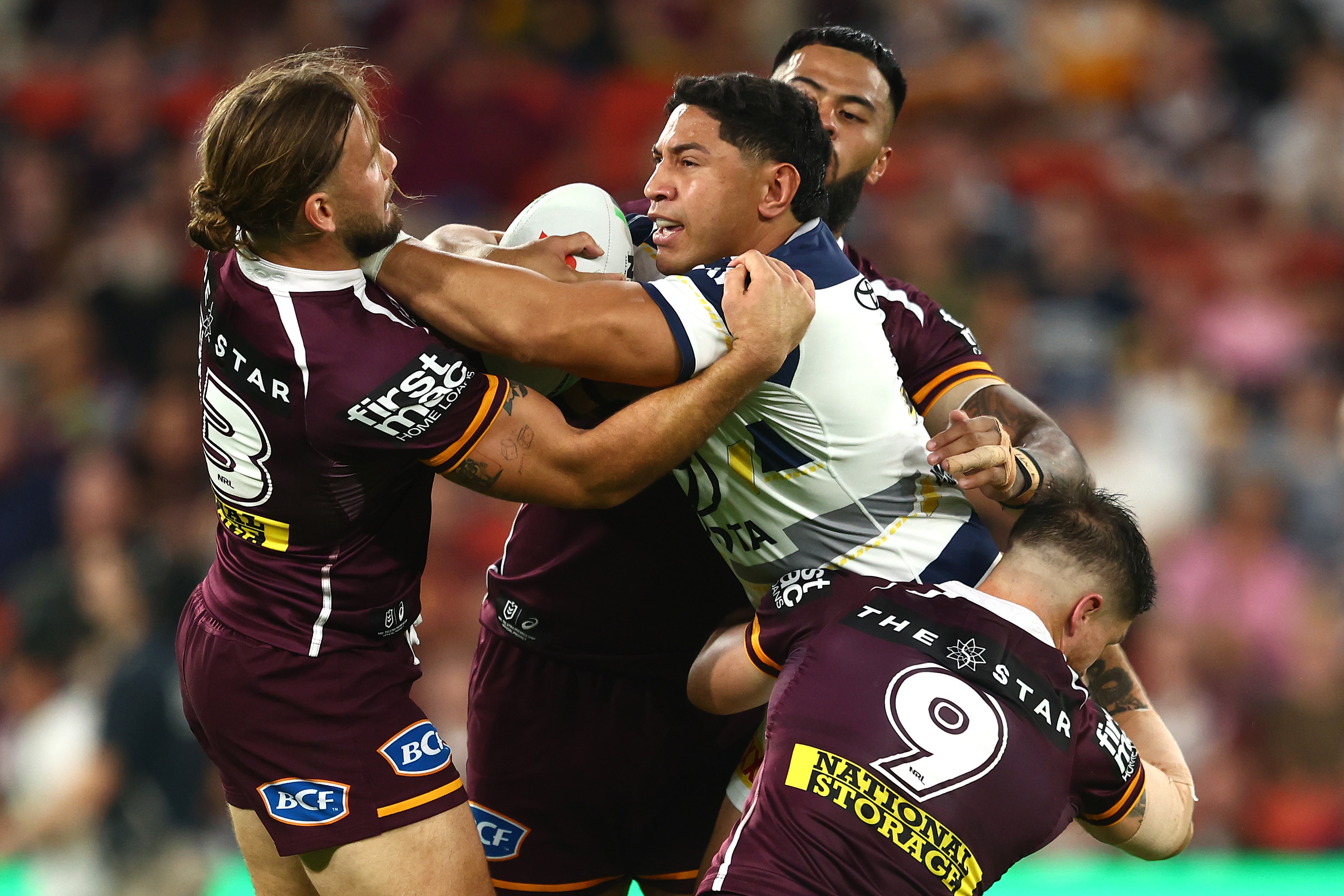 Jason runs the ball during a rugby league match.