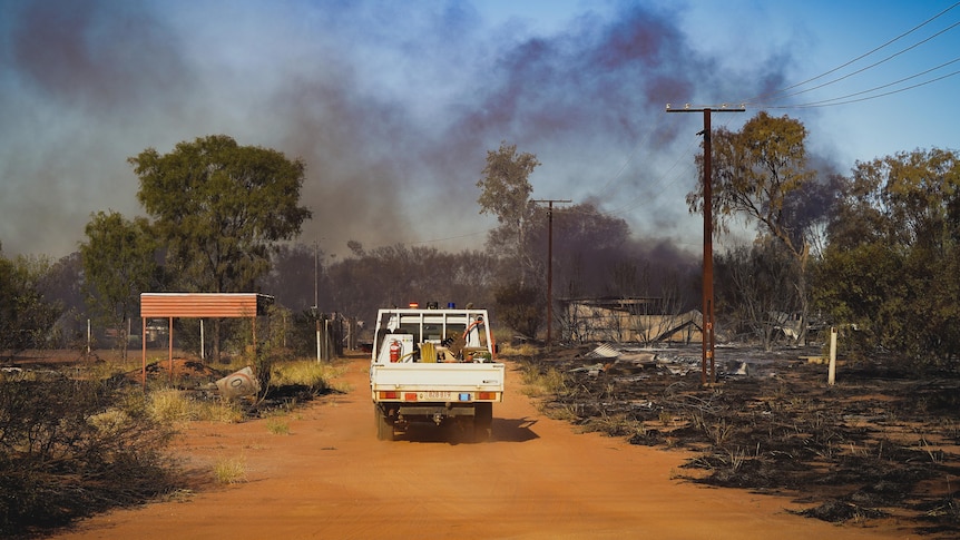 A ute drives into bushfire smoke