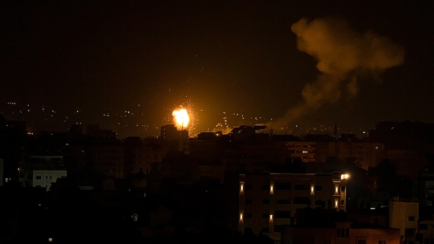 fire and smoke rising at night after an airstrike in central Gaza Strip
