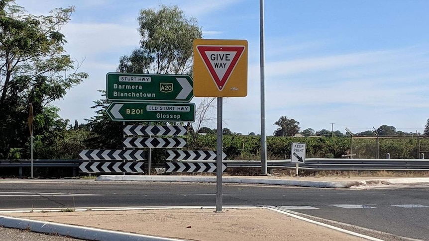 A sign next to the road