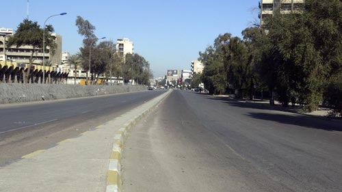 A road is deserted after a curfew was imposed in Baghdad.