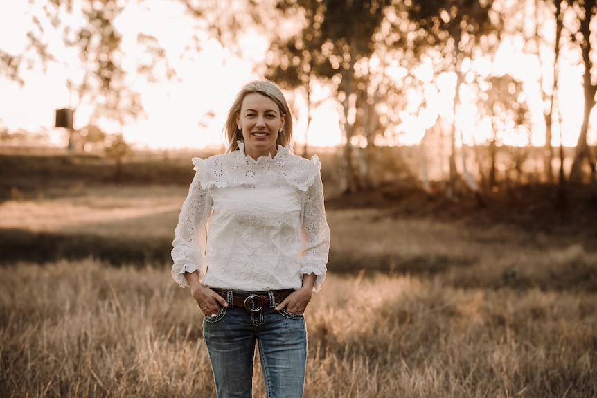 woman smiling and in a field