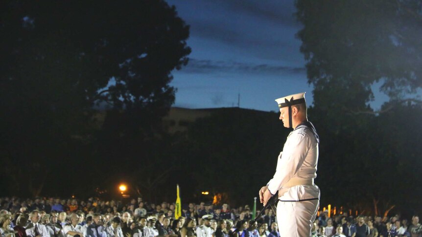 A sailor bows his head during Anzac Day service in Darwin.