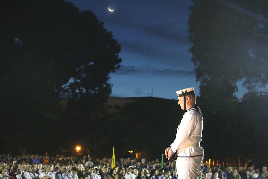 A sailor bows his head during Anzac Day service in Darwin.