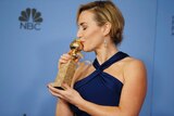 Actress Kate Winslet poses with her Golden Globe