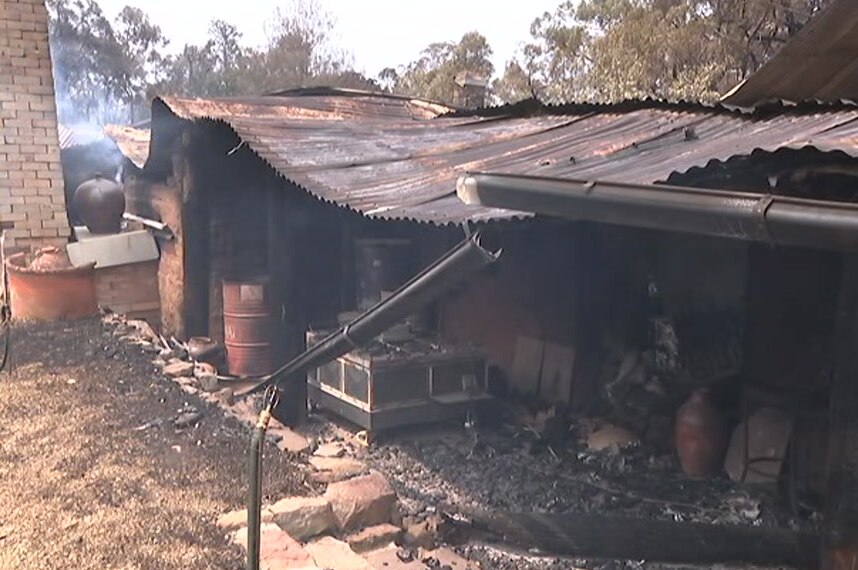 A smouldering shack, destroyed by fire.