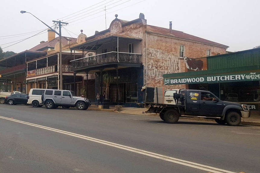 Several cars line the usually busy main street of Braidwood on a cloudy day.