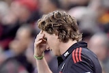 James Hird holds his head during the Bombers clash with Adelaide