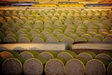 Modules and round bales of cotton waiting at a gin for processing