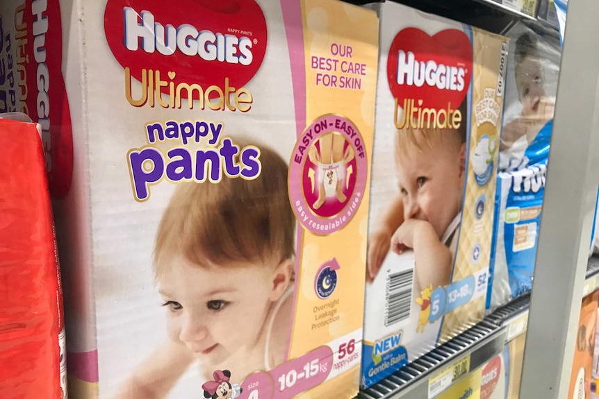Plastic nappy packaging on a shelf.
